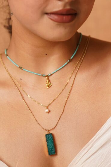 Symphony in layers?turquoise, pearl, and raw stone charm.